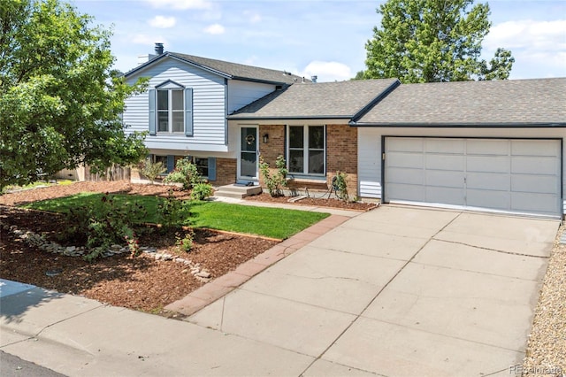 1153 S Biscay St, Aurora, CO 80017 - tri-level home featuring brick siding, driveway, a garage, and a shingled roof
