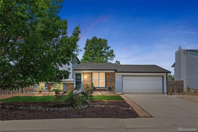 1153 S Biscay St, Aurora, CO 80017 - split level home with a garage, brick siding, and driveway