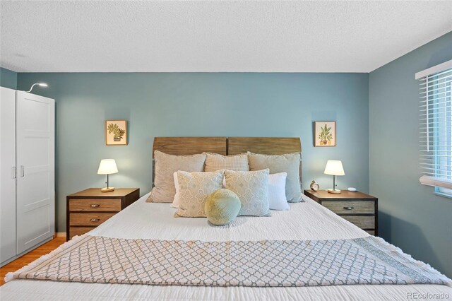 1153 S Biscay St, Aurora, CO 80017 - bedroom with wood finished floors and a textured ceiling