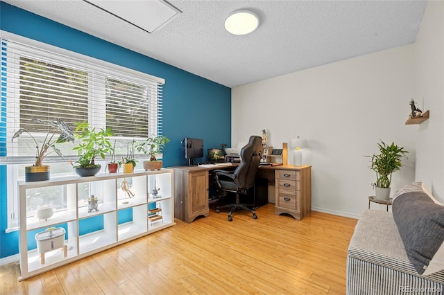 1153 S Biscay St, Aurora, CO 80017 - office space with light wood-style floors, a textured ceiling, and baseboards