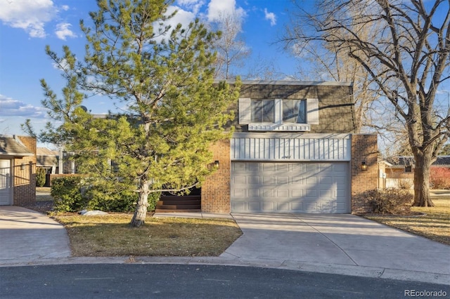 view of front of home featuring a garage, concrete driveway, and brick siding