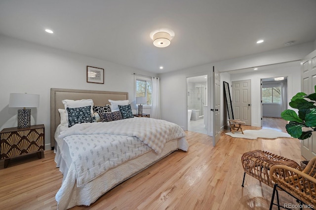 bedroom with light wood-style floors, baseboards, connected bathroom, and recessed lighting