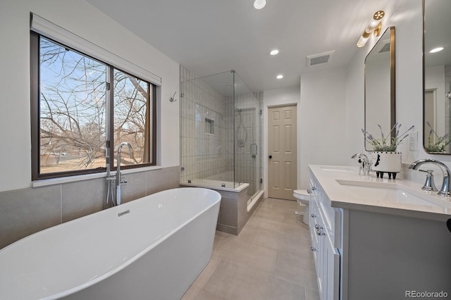 full bath featuring a soaking tub, a sink, visible vents, and a shower stall