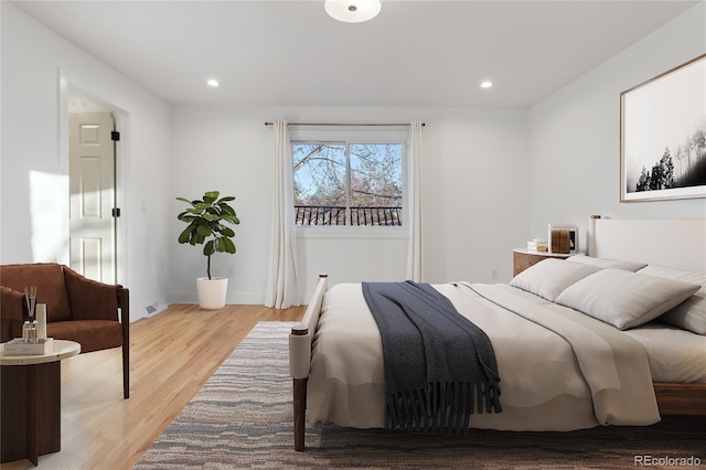 bedroom featuring light wood-style flooring, visible vents, baseboards, and recessed lighting