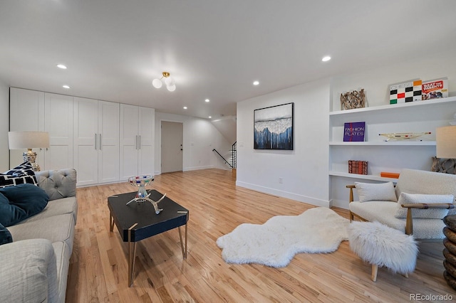 living room featuring baseboards, recessed lighting, and light wood-style floors