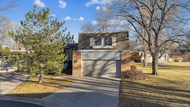 view of front facade featuring concrete driveway, brick siding, and a front yard