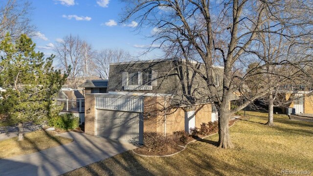 view of front facade with a front yard, brick siding, driveway, and cooling unit