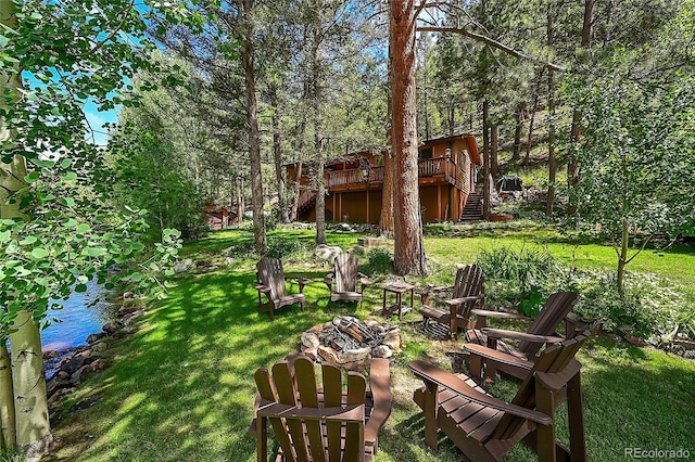 view of yard featuring a deck with water view