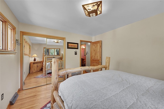 bedroom with light wood-type flooring and a closet