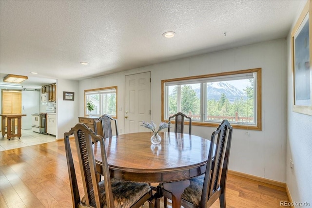 38 D Rd, Silverthorne, CO 80498 - dining area with a textured ceiling, light wood-style flooring, recessed lighting, and baseboards