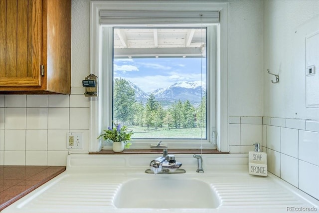 38 D Rd, Silverthorne, CO 80498 - kitchen featuring brown cabinetry, decorative backsplash, a mountain view, and light countertops