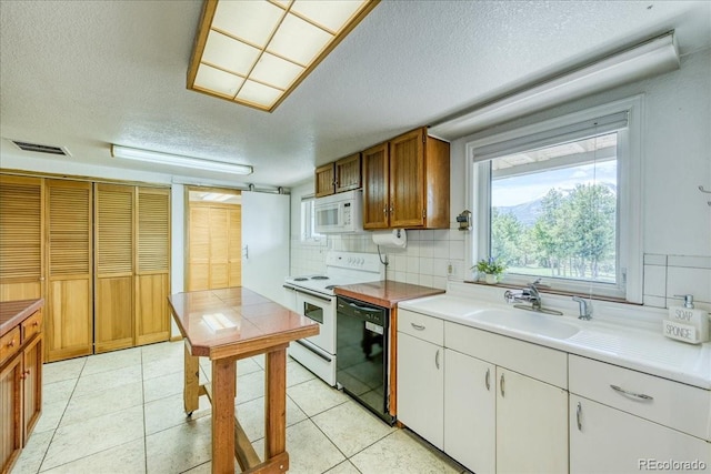 38 D Rd, Silverthorne, CO 80498 - kitchen with white appliances, a sink, a textured ceiling, backsplash, and light countertops