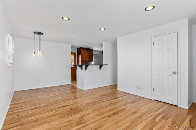 unfurnished living room with light wood-type flooring