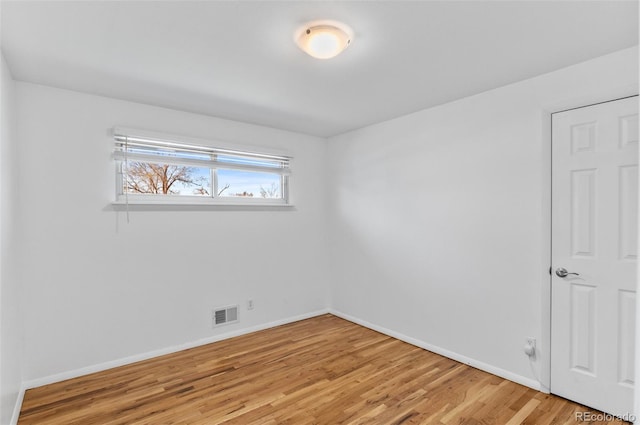 unfurnished room featuring hardwood / wood-style floors