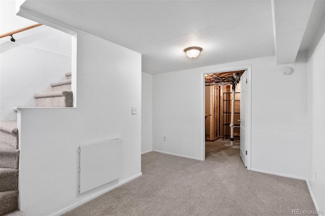 basement featuring light colored carpet