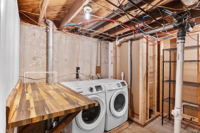 clothes washing area with washer and dryer