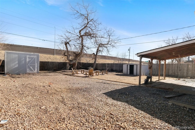 view of yard with a patio and a storage unit