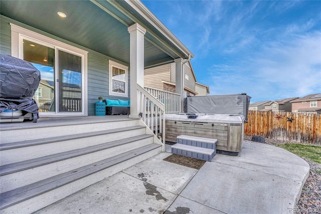 1066 S Eaton Park Ct, Aurora, CO 80018 - covered porch featuring a hot tub and a patio