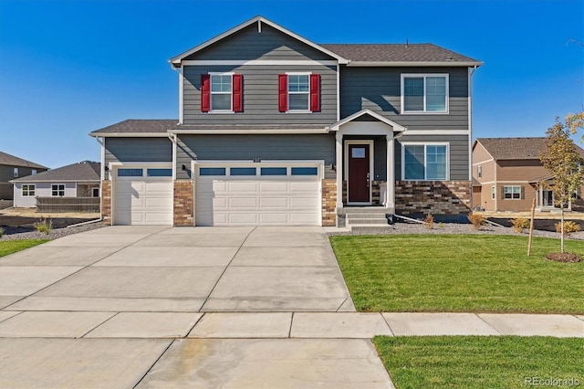 view of front of house featuring a garage and a front lawn