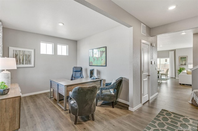 office area featuring plenty of natural light and light hardwood / wood-style flooring