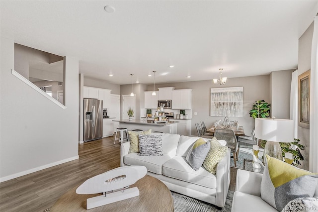 living room with dark hardwood / wood-style floors and a chandelier