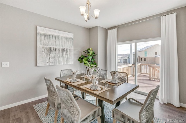 dining space with an inviting chandelier and hardwood / wood-style flooring