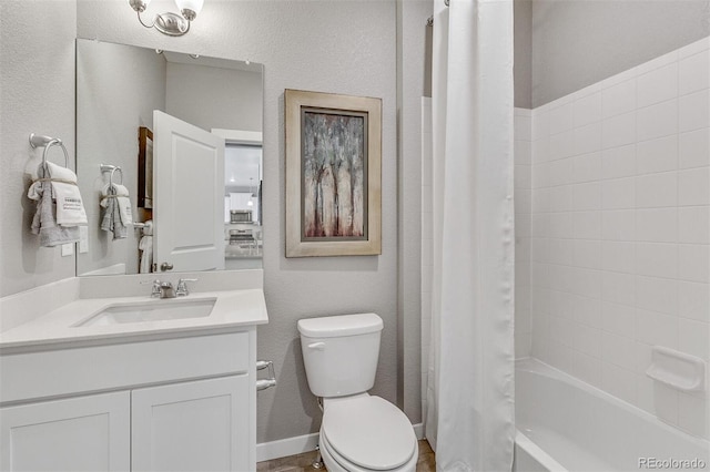 full bathroom with vanity, shower / bath combo, and toilet