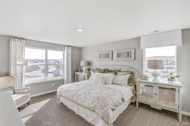 bedroom with carpet floors and a textured ceiling