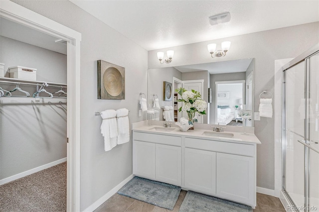 bathroom with vanity and a shower with shower door