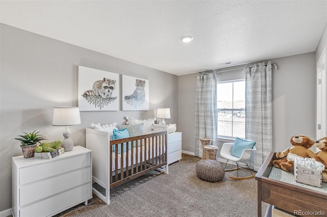 bedroom with carpet and a textured ceiling