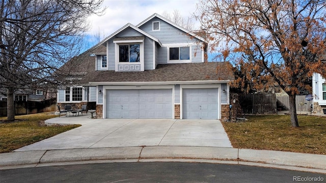 view of front facade with a garage, a patio, and a front lawn