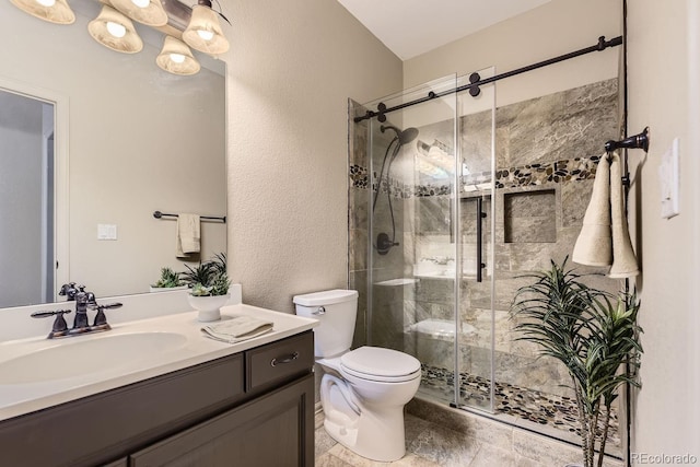 bathroom featuring vanity, an enclosed shower, and toilet