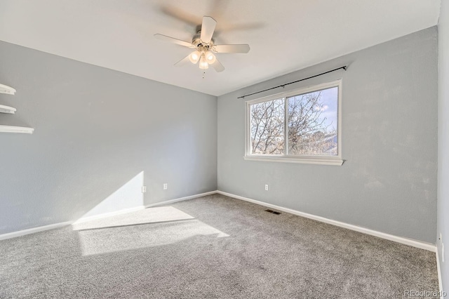 carpeted spare room with ceiling fan