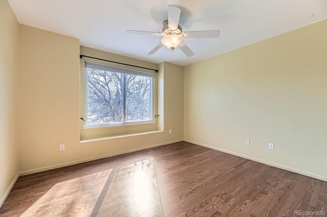 spare room with hardwood / wood-style flooring and ceiling fan