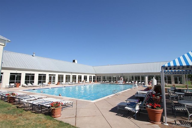 view of swimming pool featuring a patio area