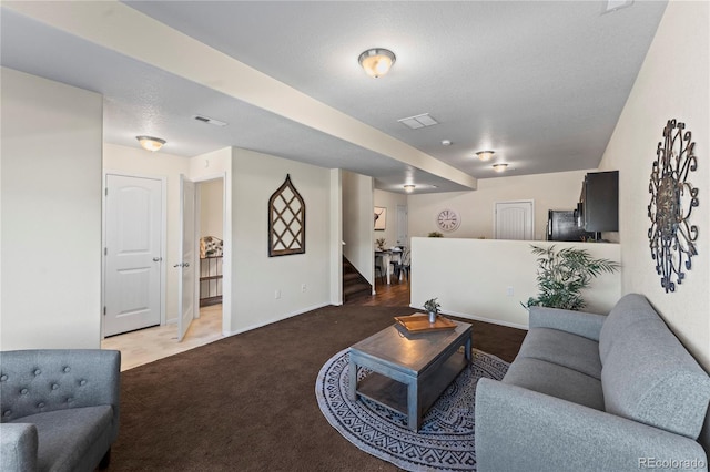 living area with carpet floors, stairway, and baseboards