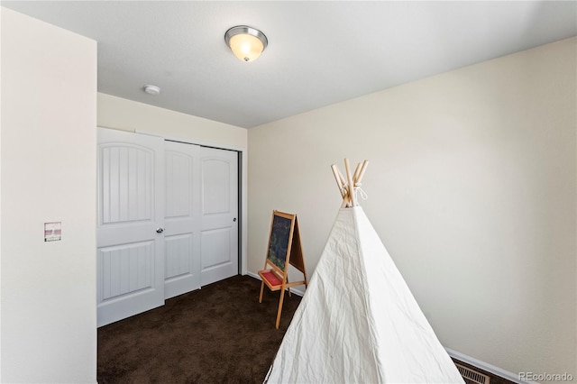 playroom with dark colored carpet
