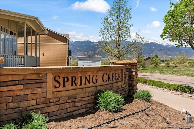 community / neighborhood sign with a mountain view