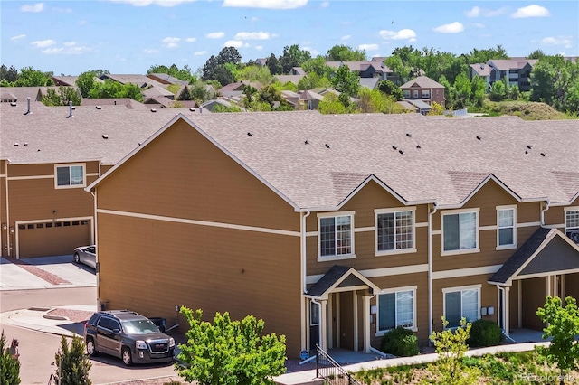 view of front facade featuring a residential view and roof with shingles