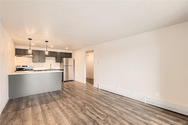 1302 S Parker Rd Unit 229, Denver, CO 80231 - kitchen with freestanding refrigerator, range with electric stovetop, a sink, light countertops, and wood finished floors