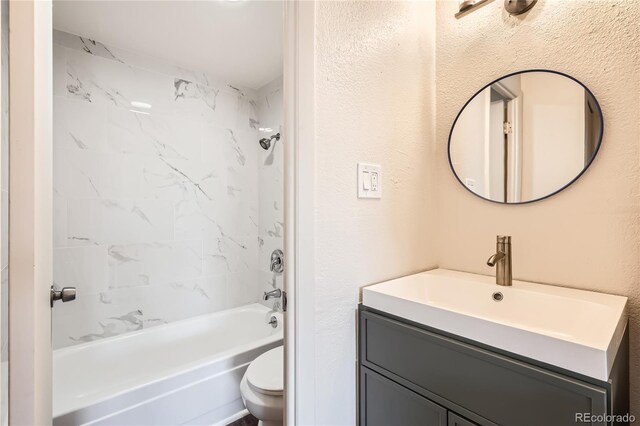 1302 S Parker Rd Unit 229, Denver, CO 80231 - full bathroom with vanity, toilet, shower / bathtub combination, and a textured wall