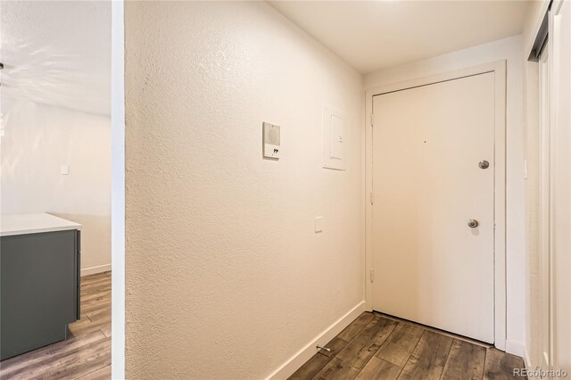 1302 S Parker Rd Unit 229, Denver, CO 80231 - hallway featuring wood finished floors, baseboards, and a textured wall