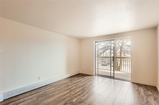1302 S Parker Rd Unit 229, Denver, CO 80231 - empty room featuring wood finished floors and baseboards