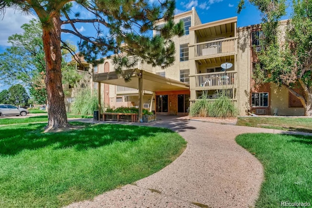 1302 S Parker Rd Unit 229, Denver, CO 80231 - view of front of home with a front yard and stucco siding