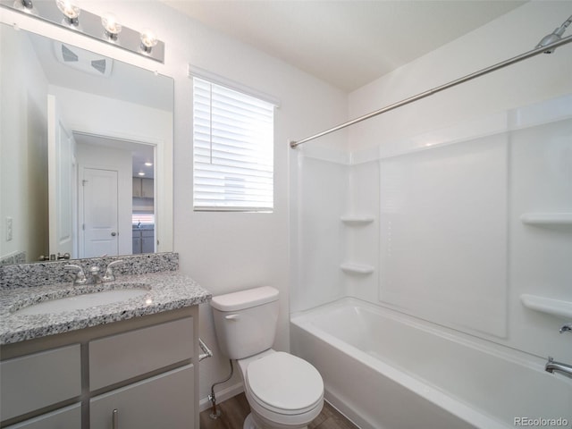 bathroom with shower / bathtub combination, wood finished floors, vanity, and toilet