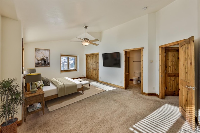 carpeted bedroom featuring ceiling fan, connected bathroom, and high vaulted ceiling