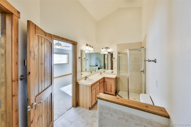 bathroom with vanity, ceiling fan, an enclosed shower, and high vaulted ceiling