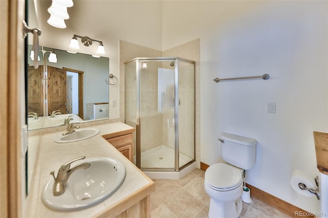 bathroom with vanity, a shower with shower door, tile patterned floors, and toilet