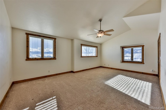 unfurnished room featuring ceiling fan, light colored carpet, and lofted ceiling