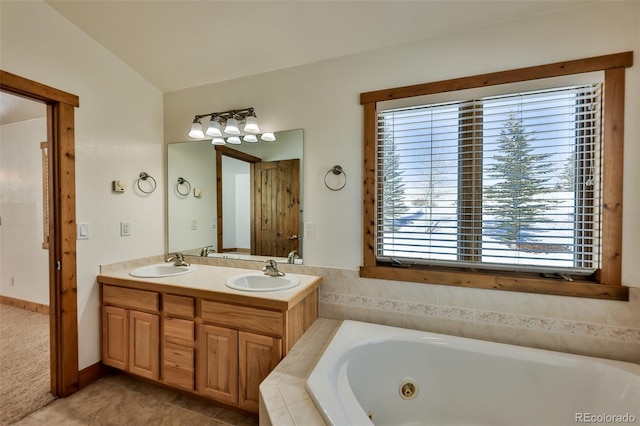 bathroom with lofted ceiling, vanity, and a relaxing tiled tub